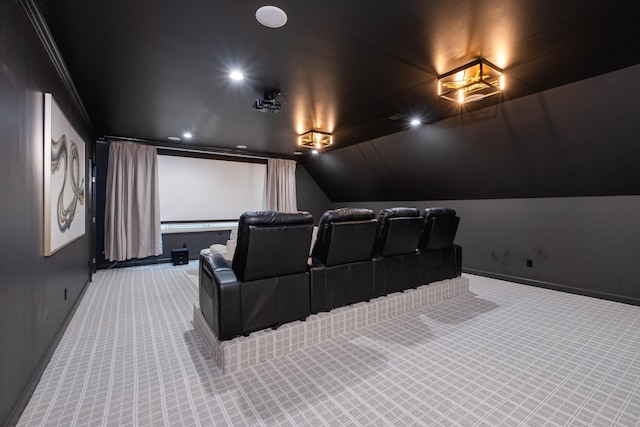 home theater room featuring lofted ceiling and carpet