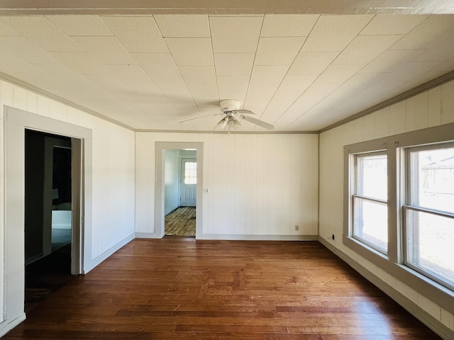 spare room with crown molding and dark hardwood / wood-style floors