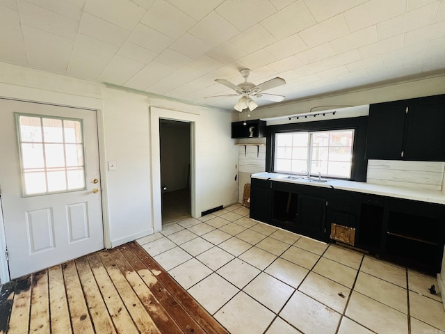 kitchen with sink, ceiling fan, and light hardwood / wood-style flooring