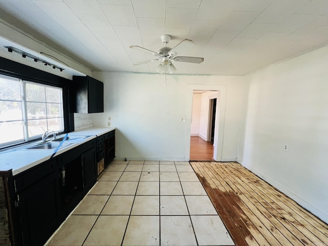 kitchen with sink, light tile patterned floors, and ceiling fan