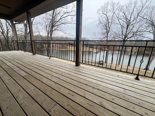 wooden terrace featuring a water view