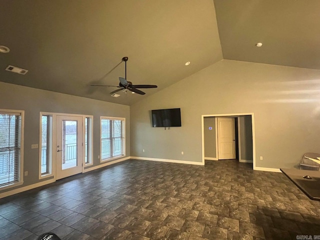 unfurnished living room with plenty of natural light, high vaulted ceiling, and ceiling fan