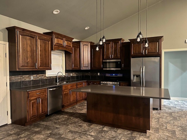 kitchen featuring appliances with stainless steel finishes, a center island, pendant lighting, and dark brown cabinetry