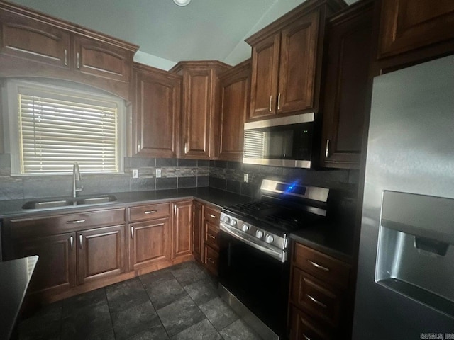 kitchen featuring appliances with stainless steel finishes, sink, and backsplash