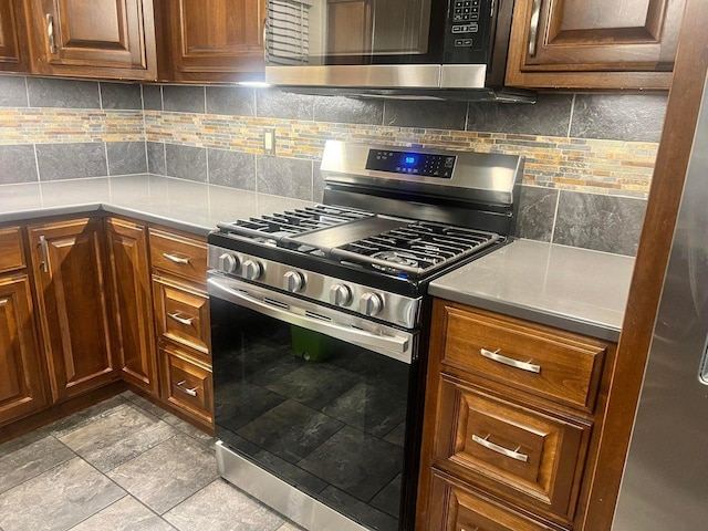 kitchen featuring stainless steel appliances and backsplash