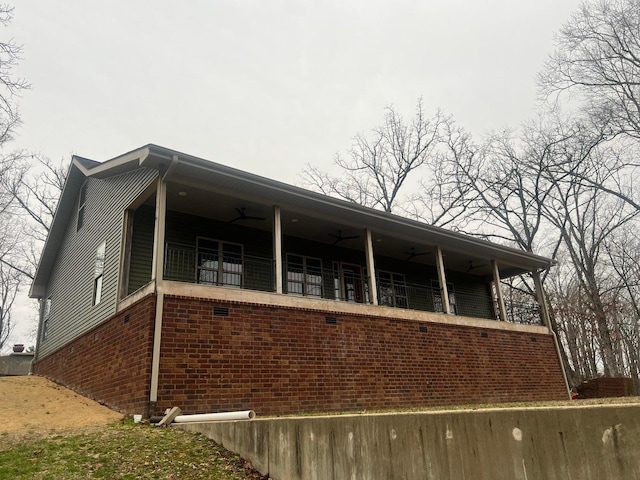 view of home's exterior featuring ceiling fan and a balcony