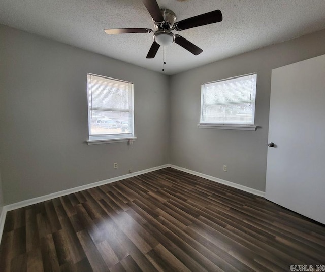 unfurnished room featuring ceiling fan, dark hardwood / wood-style floors, and a textured ceiling