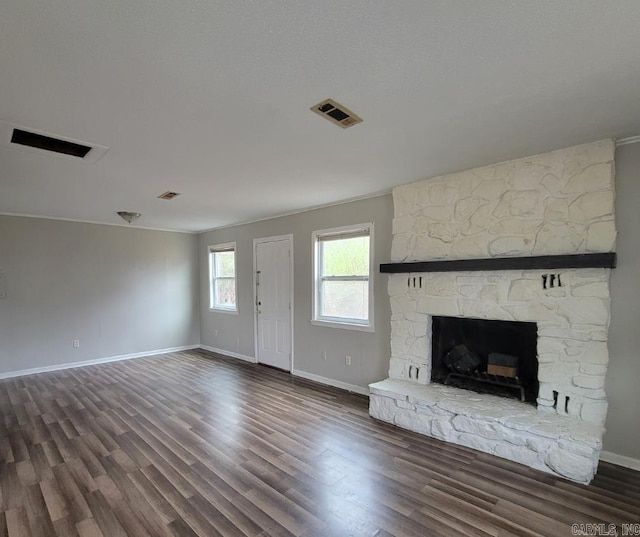 unfurnished living room with dark wood-type flooring and a fireplace