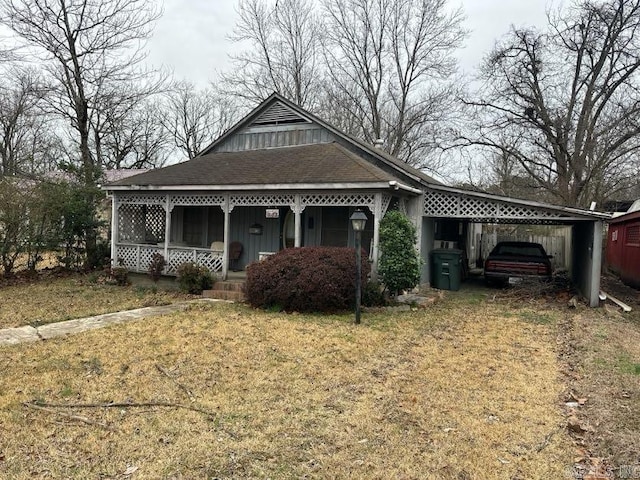 view of front of property with a front yard, a carport, and covered porch