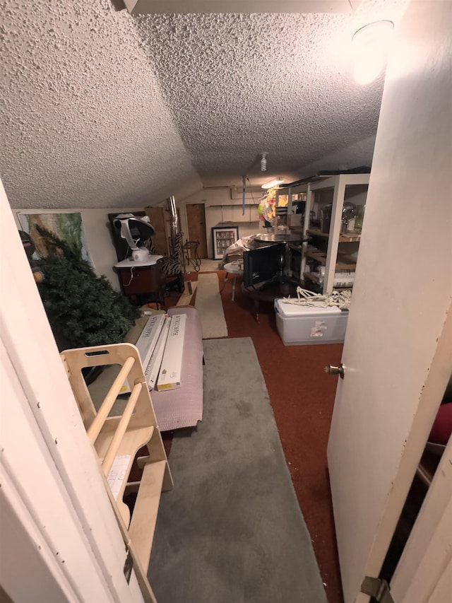 interior space featuring vaulted ceiling and a textured ceiling