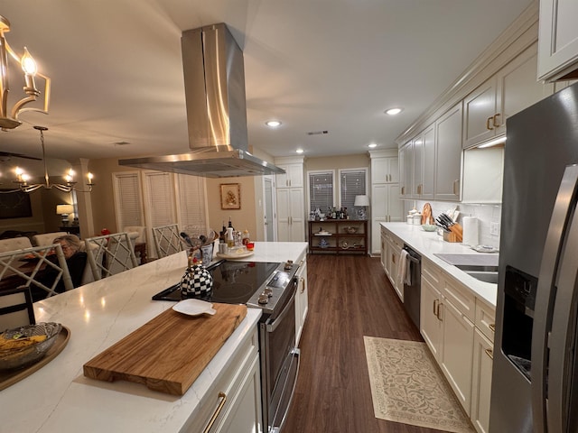 kitchen featuring sink, island range hood, hanging light fixtures, dark hardwood / wood-style flooring, and stainless steel appliances