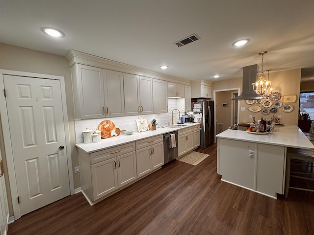 kitchen featuring stainless steel appliances, island range hood, dark hardwood / wood-style floors, and pendant lighting