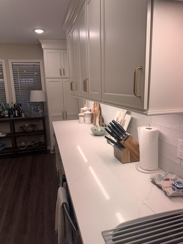 laundry area with dark hardwood / wood-style flooring