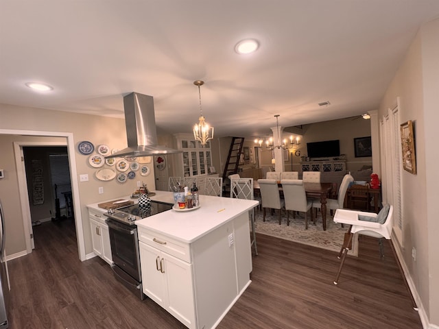 kitchen with pendant lighting, white cabinetry, dark hardwood / wood-style floors, island range hood, and stainless steel electric range oven