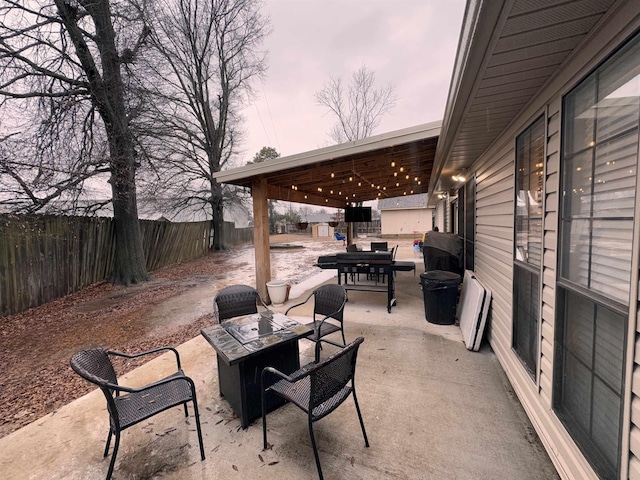 patio terrace at dusk featuring a fire pit