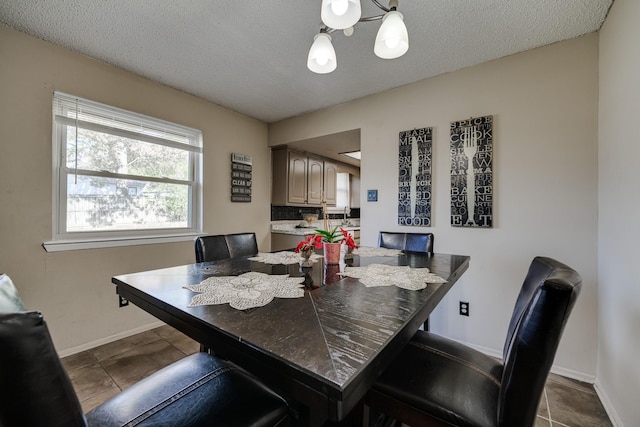 dining room featuring tile patterned flooring and a textured ceiling