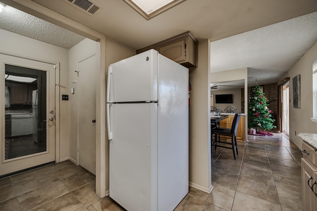 kitchen featuring white appliances and a textured ceiling