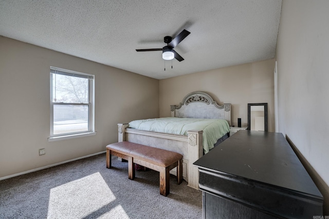 carpeted bedroom featuring ceiling fan and a textured ceiling