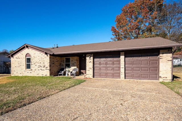 ranch-style house featuring a garage and a front yard