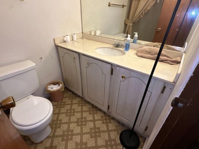 bathroom featuring vanity and toilet