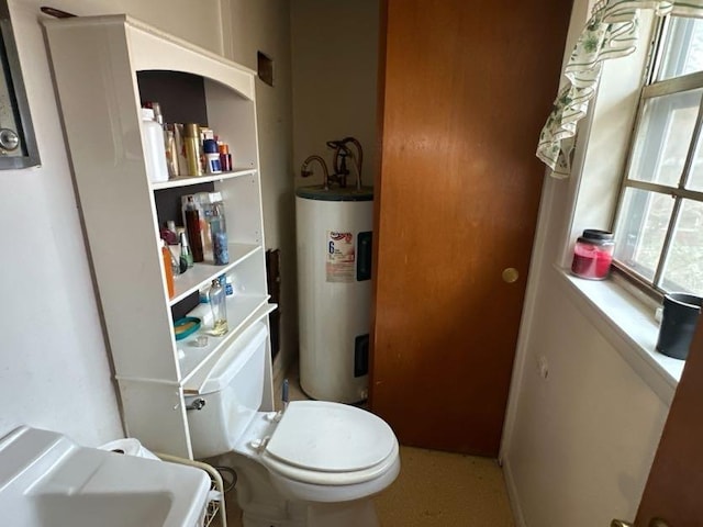 bathroom with electric water heater and toilet