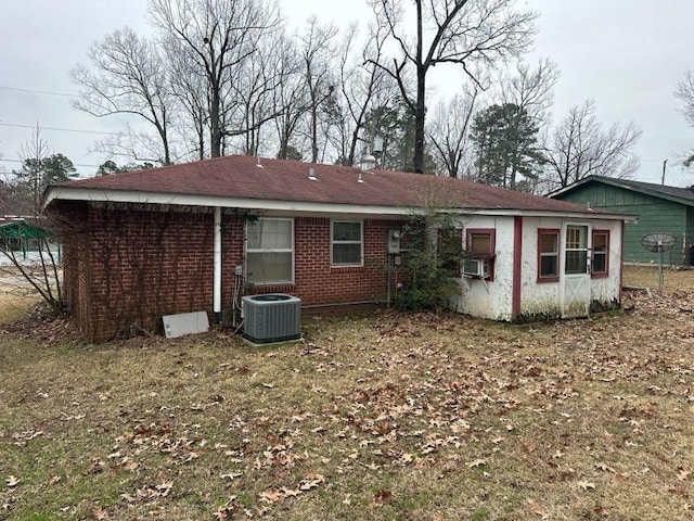 back of house featuring central AC and a yard