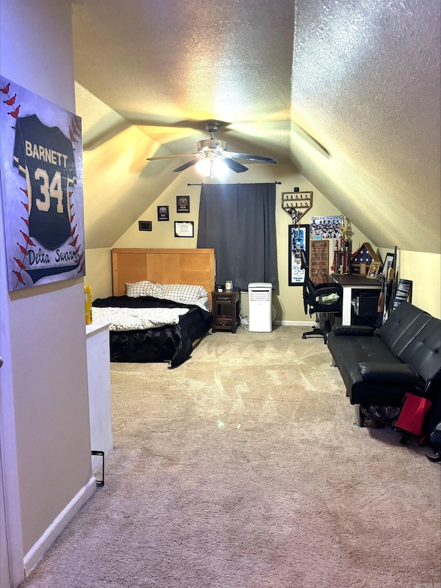 carpeted bedroom featuring ceiling fan, lofted ceiling, and a textured ceiling