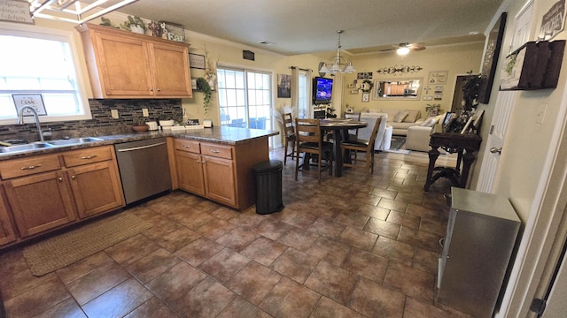 kitchen featuring a wealth of natural light, sink, backsplash, stainless steel dishwasher, and kitchen peninsula