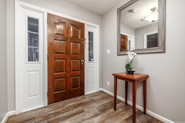 entrance foyer with hardwood / wood-style flooring and a textured ceiling