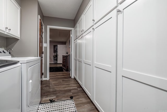 clothes washing area featuring cabinets, dark hardwood / wood-style flooring, washer and clothes dryer, and a textured ceiling