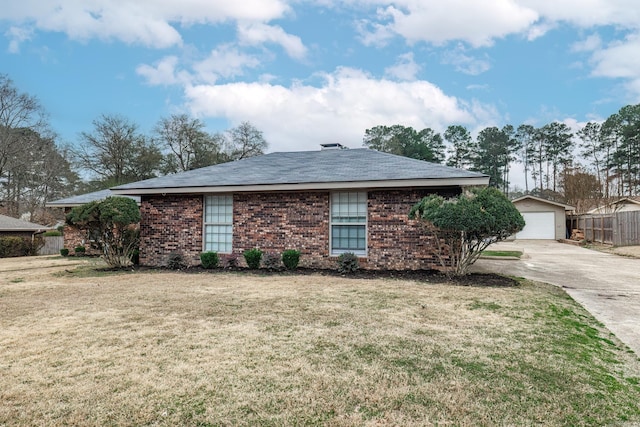 view of front facade featuring a garage, an outbuilding, and a front yard