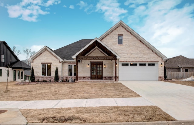 view of front of home with a garage, a front lawn, and french doors