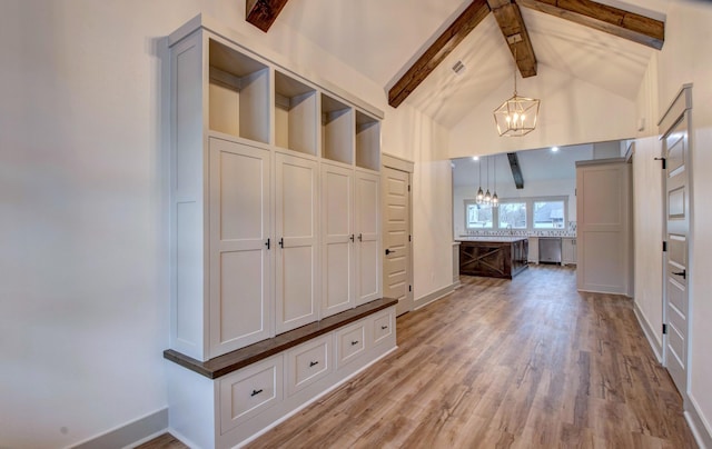 mudroom with hardwood / wood-style flooring, a chandelier, and vaulted ceiling with beams