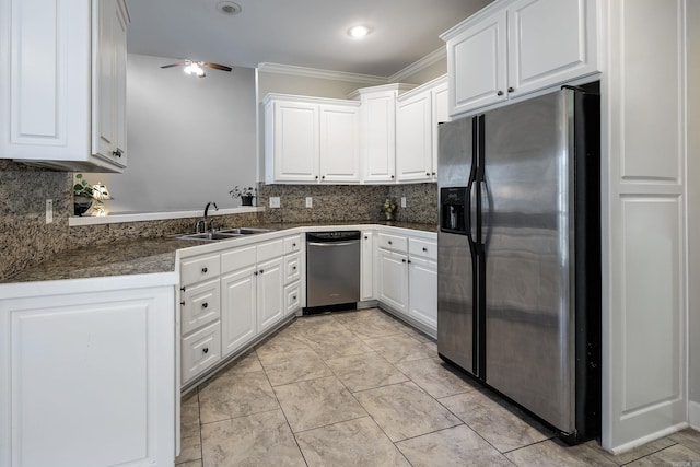 kitchen with white cabinetry, appliances with stainless steel finishes, ornamental molding, ceiling fan, and backsplash