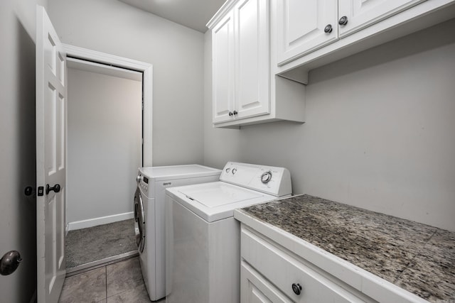 laundry area featuring cabinets, washing machine and clothes dryer, and light tile patterned flooring