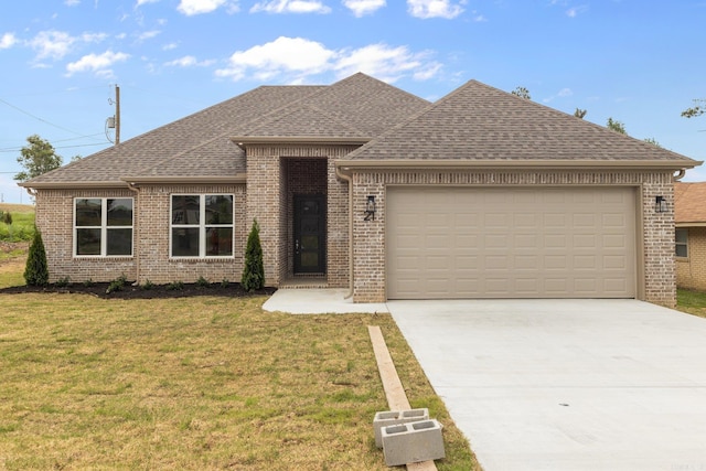 view of front of house with a garage and a front lawn