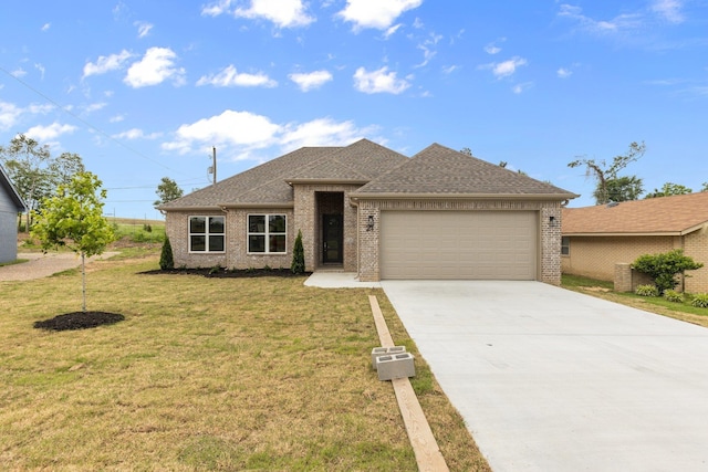 view of front of property with a garage and a front lawn