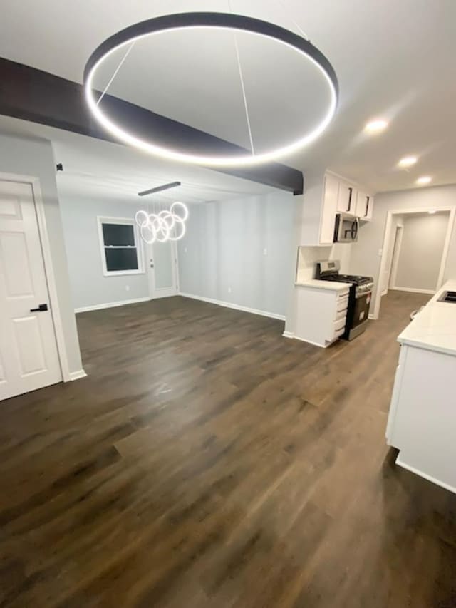 unfurnished living room featuring dark hardwood / wood-style flooring