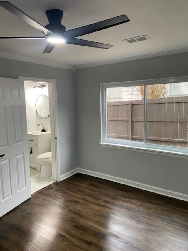 unfurnished bedroom featuring sink, ensuite bath, ceiling fan, ornamental molding, and dark hardwood / wood-style flooring