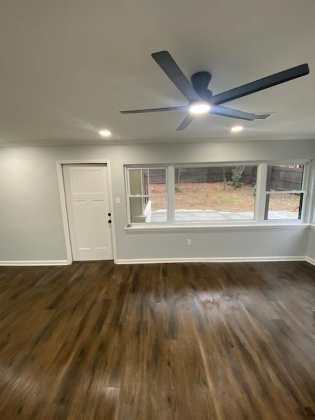 empty room featuring dark hardwood / wood-style floors and ceiling fan