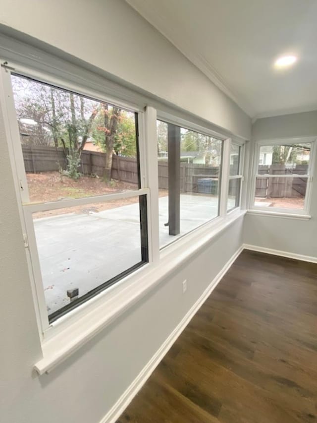 unfurnished sunroom featuring vaulted ceiling