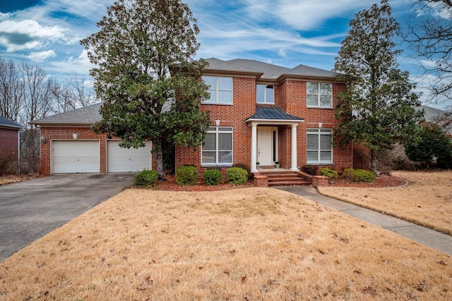 view of front of house featuring a garage and a front lawn