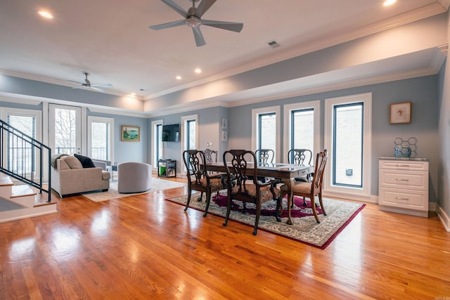 dining area with crown molding, light hardwood / wood-style floors, and ceiling fan