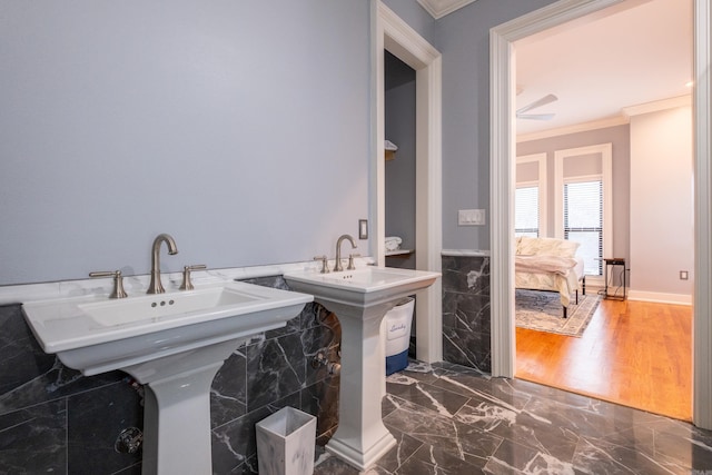 bathroom featuring double sink and crown molding