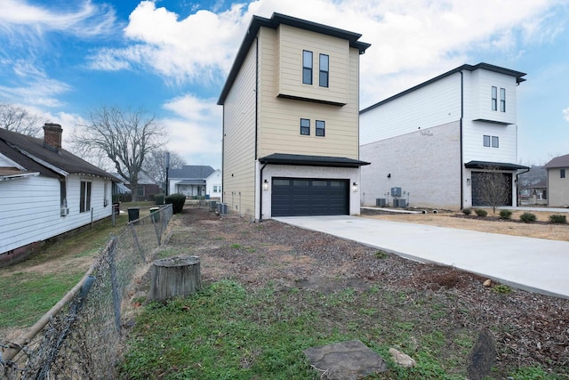 view of side of home featuring a garage and central air condition unit