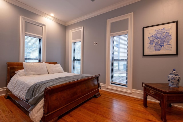 bedroom featuring ornamental molding and wood-type flooring