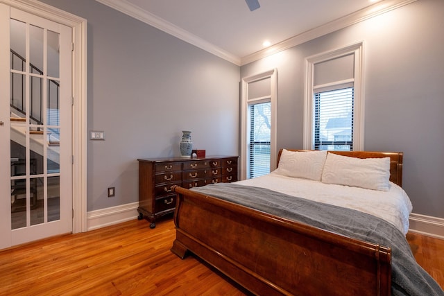 bedroom featuring crown molding, ceiling fan, and light hardwood / wood-style floors