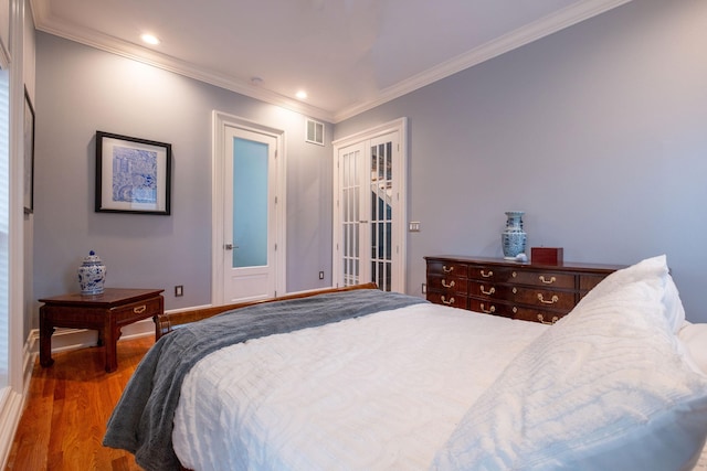 bedroom with dark wood-type flooring and ornamental molding