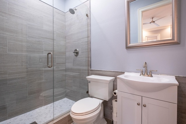 bathroom with vanity, toilet, and a shower with door