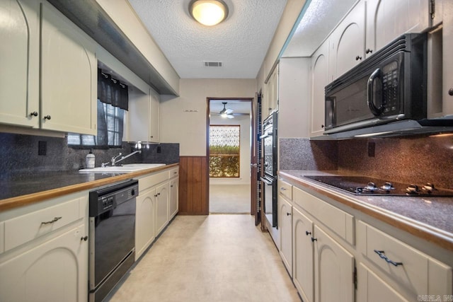 kitchen with decorative backsplash, sink, a textured ceiling, and black appliances